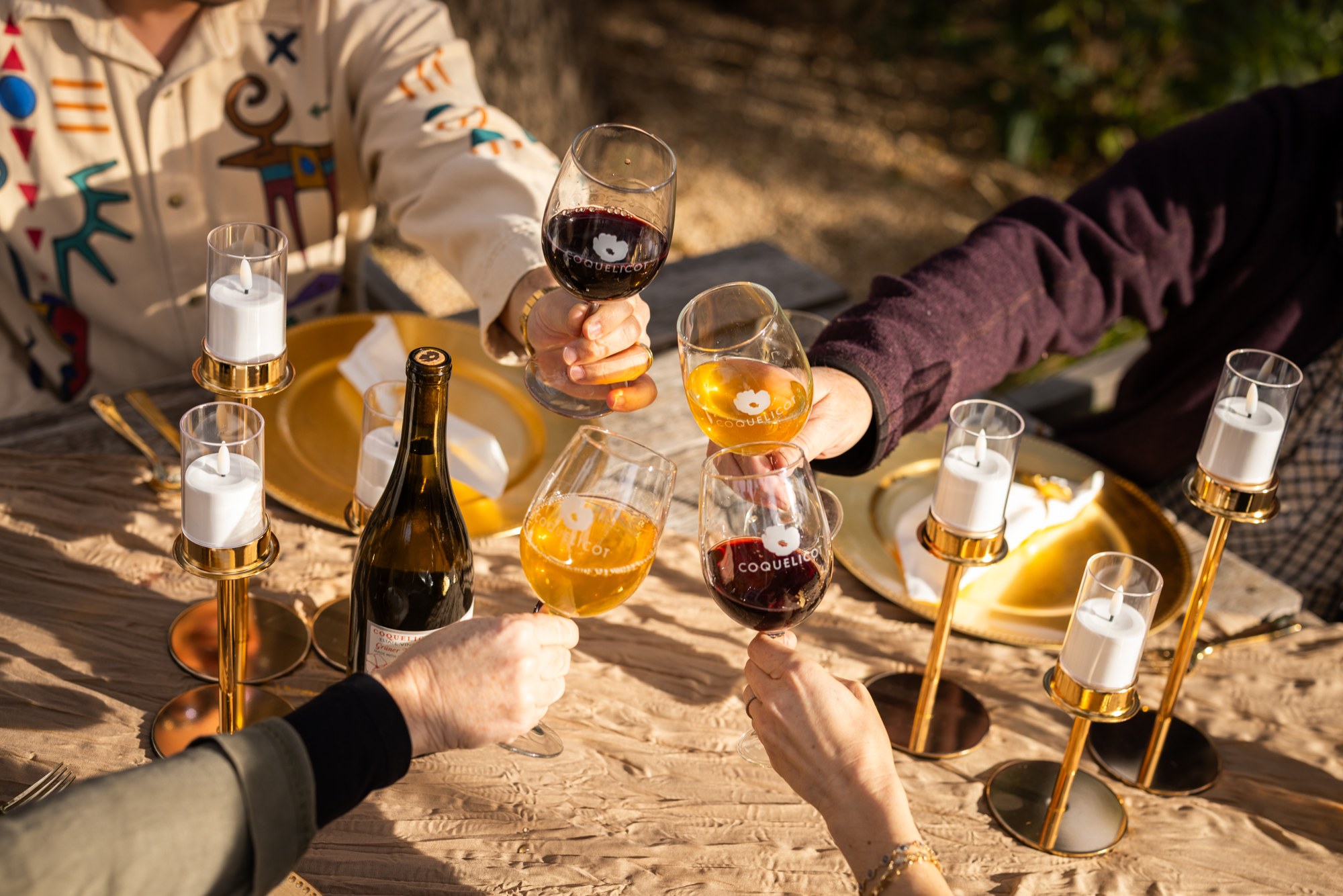 Friends raising glasses around a table