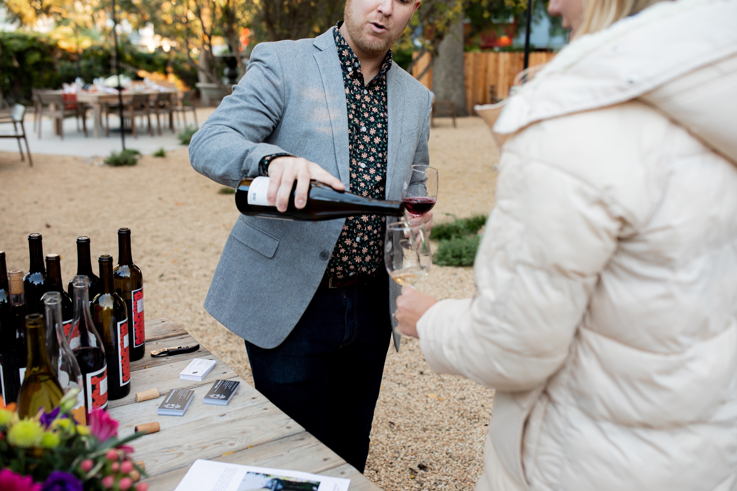 Red wine being poured for guests in the tasting garden
