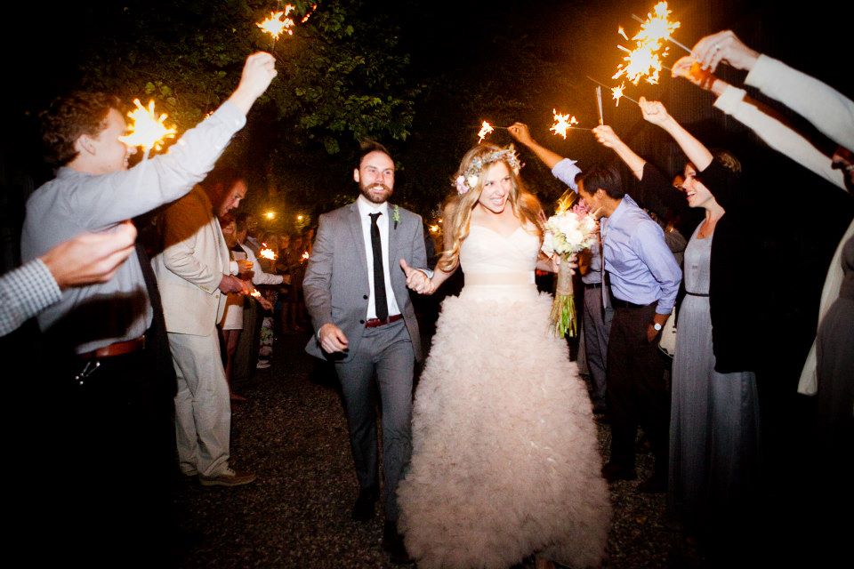 A wedding couple walking through a sparkler send-off