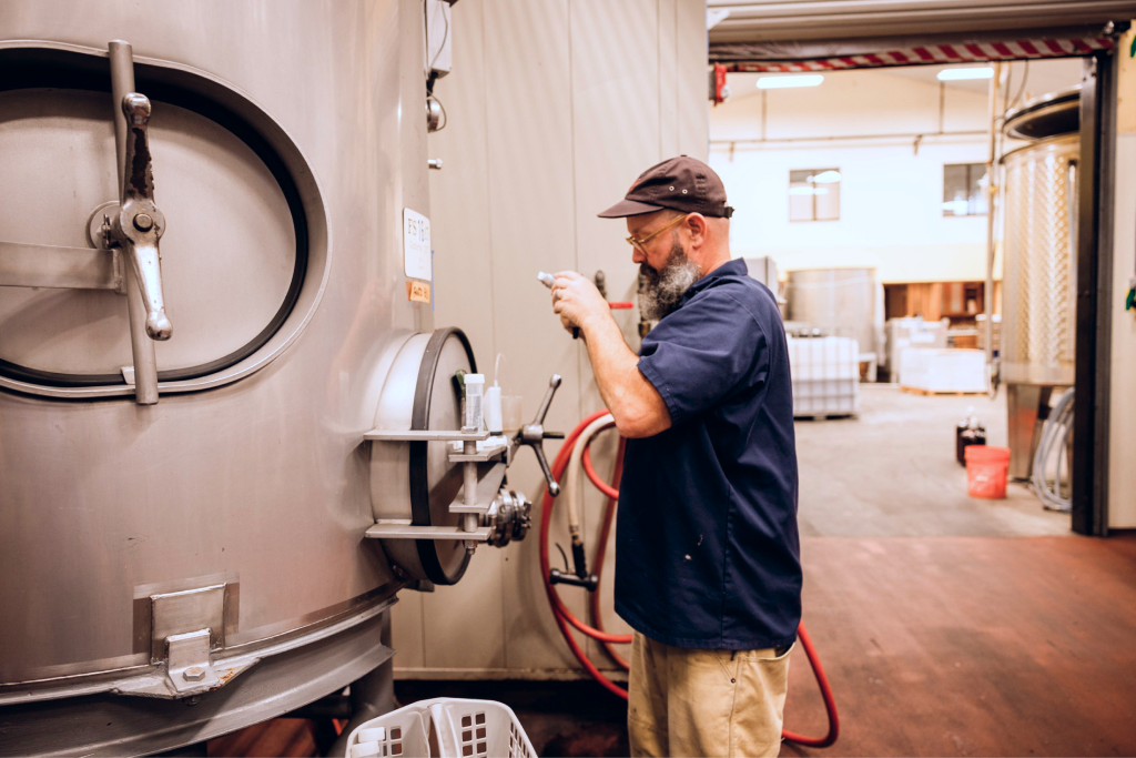 Cellar work beside stainless steel tanks